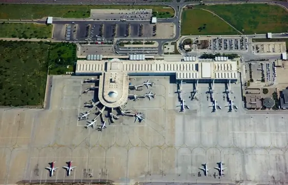 Aerial view of Antalya Airport with planes at the gates, reflecting the hub's bustling activity and importance in Turkey's tourism